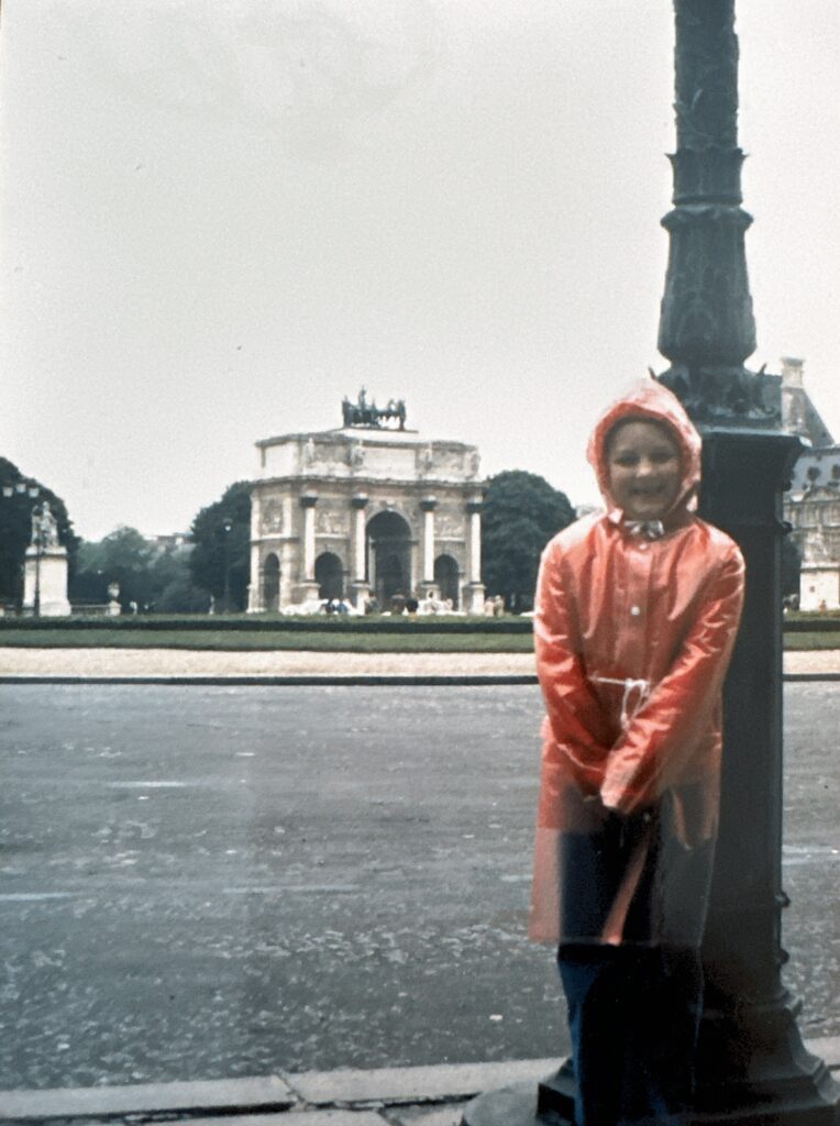 Vintage picture of young Jenny in front of the Arc de Triomphe du Carrousel, Paris, France, 1980